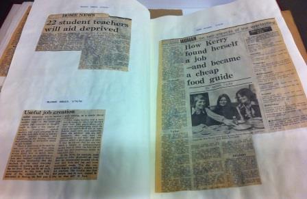 photograph of newspaper articles pasted into a book