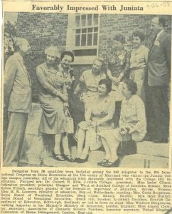 Newspaper cutting with photograph of delegates from the conference sitting outside on the College steps